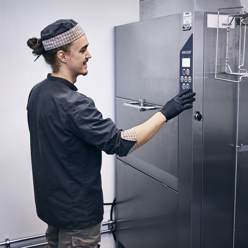 Guy operating machine in a tight space