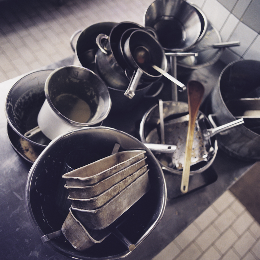 A lot of pots and utensils needs to be washed